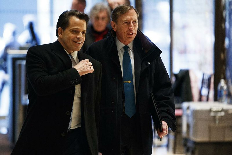 Anthony Scaramucci (left), an adviser to President-elect Donald Trump, walks with former CIA Director and retired Gen. David Petraeus on Monday at Trump Tower in New York.