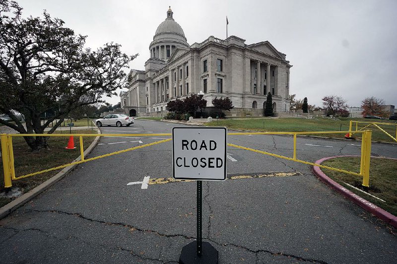 A new sign and gates block the eastern driveway at the state Capitol on Sunday. The secretary of state’s office, which maintains the building and grounds, said the driveway will be closed on weekends to prevent parking and through traffic. The building remains open to weekend visitors.