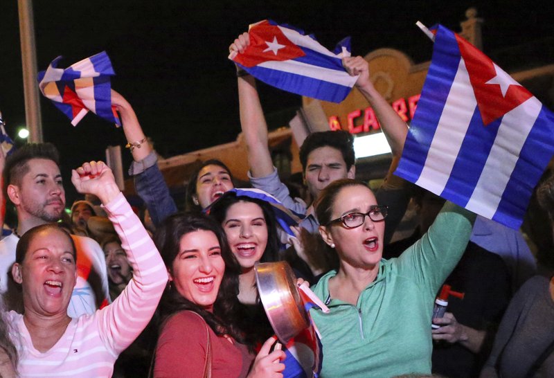 In this Nov. 25, 2016, file photo, the Cuban community in Miami celebrates the announcement that Fidel Castro died in front La Carreta Restaurant early in Miami. 