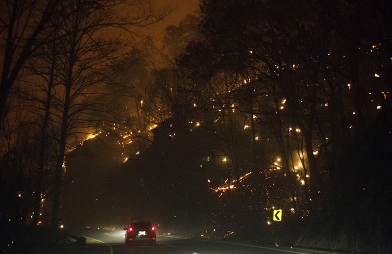 Fire erupts on both side of Highway 441 between Gatlinburg and Pigeon Forge, Tenn., Monday, Nov. 28, 2016. In Gatlinburg, smoke and fire caused the mandatory evacuation of downtown and surrounding areas, according to the Tennessee Emergency Management Agency. (Jessica Tezak/Knoxville News Sentinel via AP)

