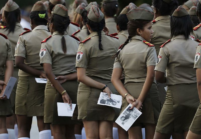 Cadets from a Cuban military school wait Tuesday to attend a rally honoring Fidel Castro’s memory at the Revolution Plaza in Havana, where Castro spoke to crowds in the years after he seized power. 