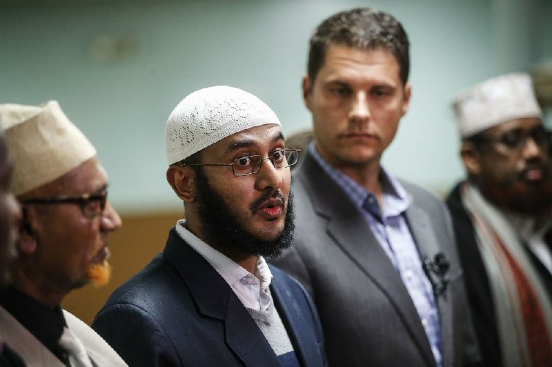 Ahmed Ahmed, director of the Ibnu Taymaya Masjid & Islamic Center, speaks alongside Columbus City Council President Zach Klein (center right) at a news conference Tuesday in his mosque in Columbus, Ohio, after Monday’s attack at the Ohio State University campus.