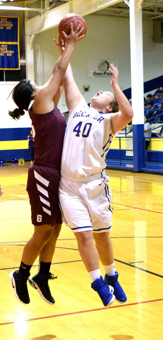 Photo by Mike Eckels Chastery Fuamatu (Gentry 25) and Cameron Shaffer (Decatur 40) fight for possession of the basketball during the Nov. 22 Lady Bulldog-Lady Pioneer matchup at Peterson Gym in Decatur.