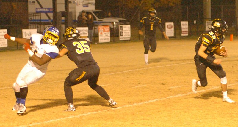 MARK HUMPHREY ENTERPRISE-LEADER Prairie Grove senior Stone Bryant (right) returns an interception while teammate Kyle Sam blocks. Bryant alertly picked off a Gosnell pass at the goal line that was tipped by Isaac Disney. The Tigers defeated Gosnell, 48-26, to advance to Friday&#8217;s State 4A semifinal playoff against Warren.