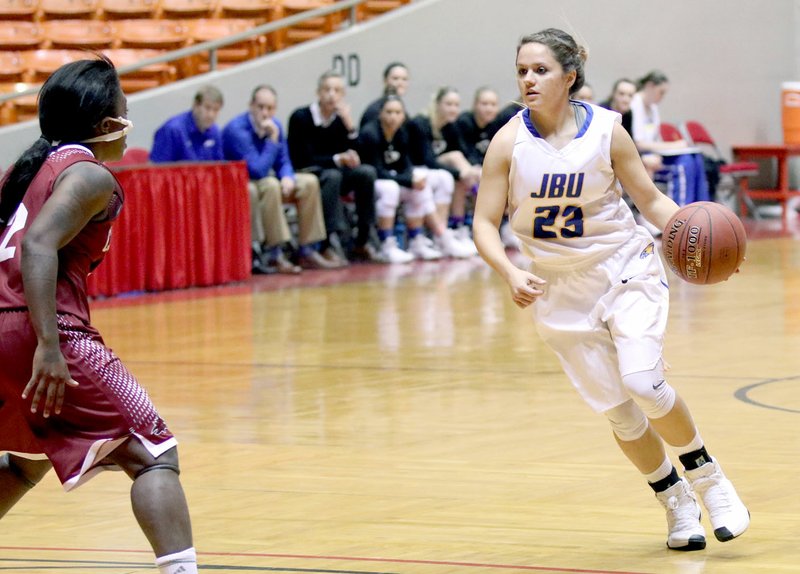 Jordan Alves/Campbellsville (Tenn.) University John Brown University senior Kodee Powell, right, drives to the basket against Cumberland (Tenn.) on Saturday in the Rotary Classic at Oman Arena in Jackson, Tenn. Powell hit the game-winning 3-pointer for John Brown in the Golden Eagles&#8217; 66-64 victory over the Phoenix.