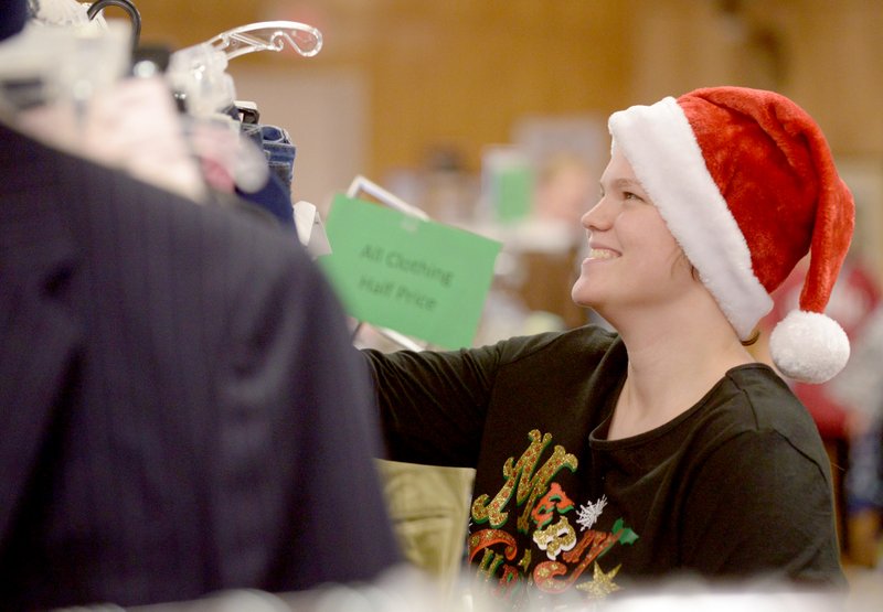 Photo by Ben Goff Desaray Botteron of Gentry volunteered on Friday during a Black Friday sale at the Helping Hands thrift store in Bentonville.