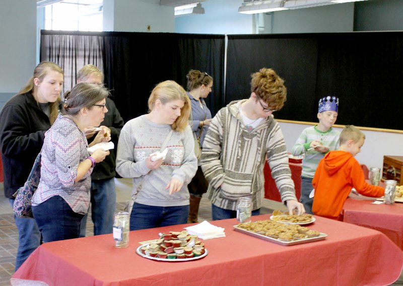 Michael Burchfiel/Herald-Leader A muffin contest was held in the old post office. Tasters voted by placing money in their favorite&#8217;s jar.