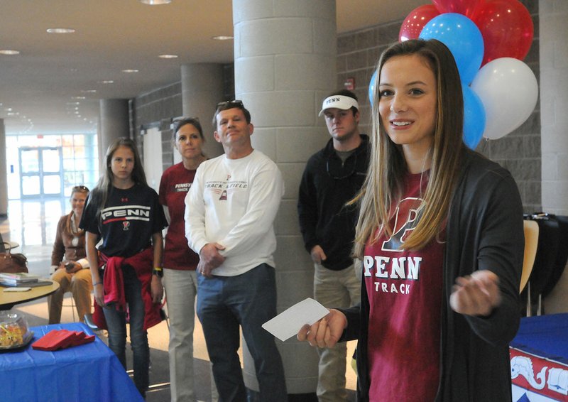 Hannah Lueders (right) talks to Rogers High students Tuesday at her signing ceremony in Rogers.