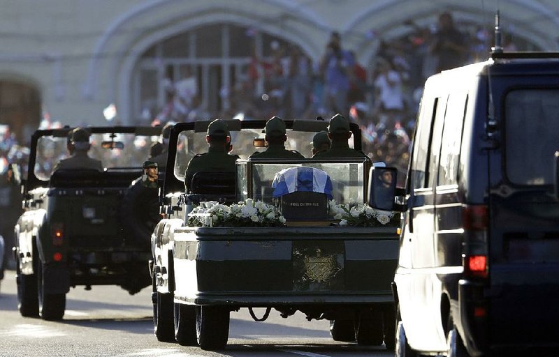 Placed in a small coffin covered by a Cuban flag, the ashes of former Cuban leader Fidel Castro are driven along the streets of the port of Havana, on Wednesday.