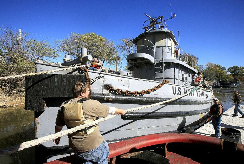 Pearl Harbor survivor the USS Hoga is eased into place at the Arkansas Inland Maritime Museum in North Little Rock on Nov. 23, 2015. The veteran Navy tug is a National Historic Landmark.