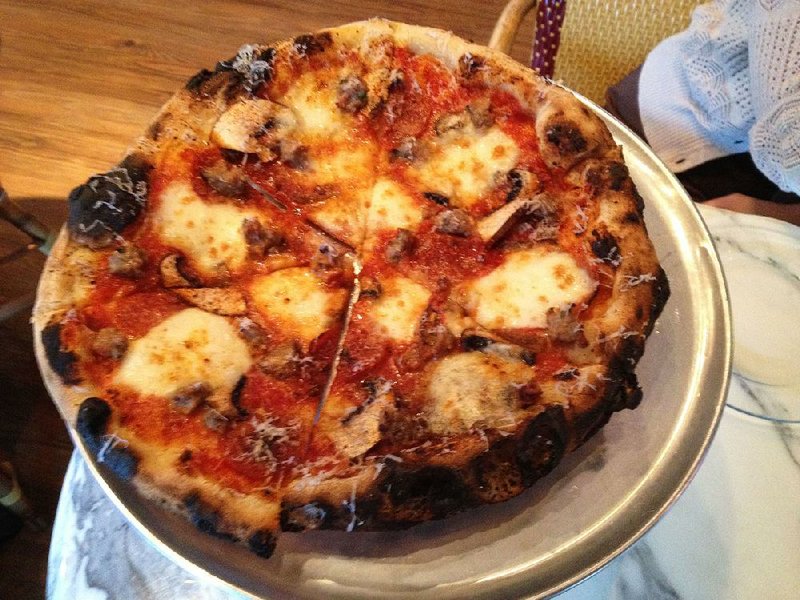 Neapolitan-style pizzas like this Pop Supreme will start popping out of the big, imported oven Friday at The Pizzeria, formerly the Pizzeria @ Terry’s Finer Foods.