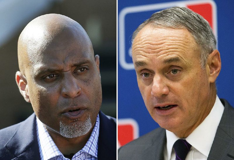 At left, in a March 17, 2015, file photo, Major League Baseball Players Association executive and former Detroit Tigers first baseman Tony Clark talks to the media before a spring training exhibition baseball game in Lakeland, Fla. At right, in a May 19, 2016, file photo, Baseball Commissioner Rob Manfred speaks to reporters during a news conference at Major League Baseball headquarters in New York. 