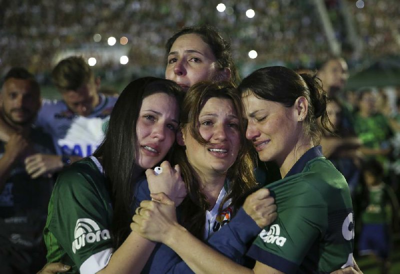 Relatives of soccer players killed in Tuesday’s crash in Colombia attend a memorial service Wednesday at the team’s home stadium in Chapeco, Brazil.