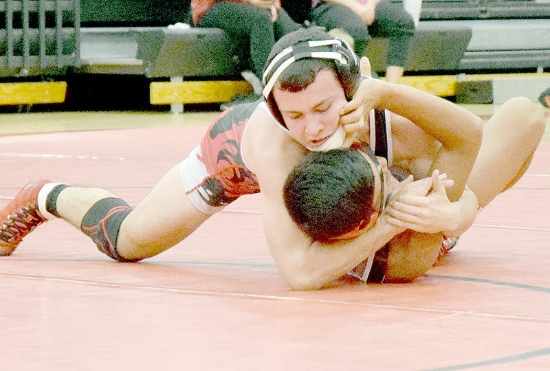 PHOTO BY RICK PECK McDonald County&#8217;s Jakob Gerow ignores a hand to his face as he pins teammate Johann De La Cruz at the 8th Annual Red/Black Dual held Nov. 22 at MCHS.