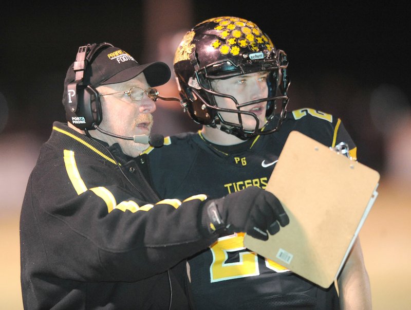 Prairie Grove coach Danny Abshier (left) speaks to Clay Fidler on Nov. 18 during their game against Central Arkansas Christian at Tiger Stadium in Prairie Grove.
