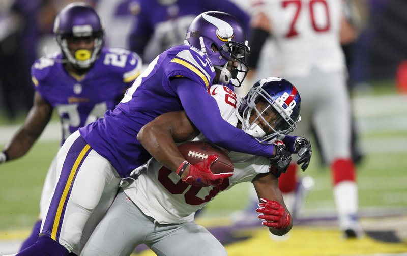 In this Oct. 3, 2016, file photo, Minnesota Vikings cornerback Terence Newman, left, tackles New York Giants wide receiver Victor Cruz during the first half of an NFL football game, in Minneapolis. Thirteen years after the Dallas Cowboys drafted Terence Newman, the old cornerback is still going strong for the Minnesota Vikings. His current team faces his original team on Thursday. 