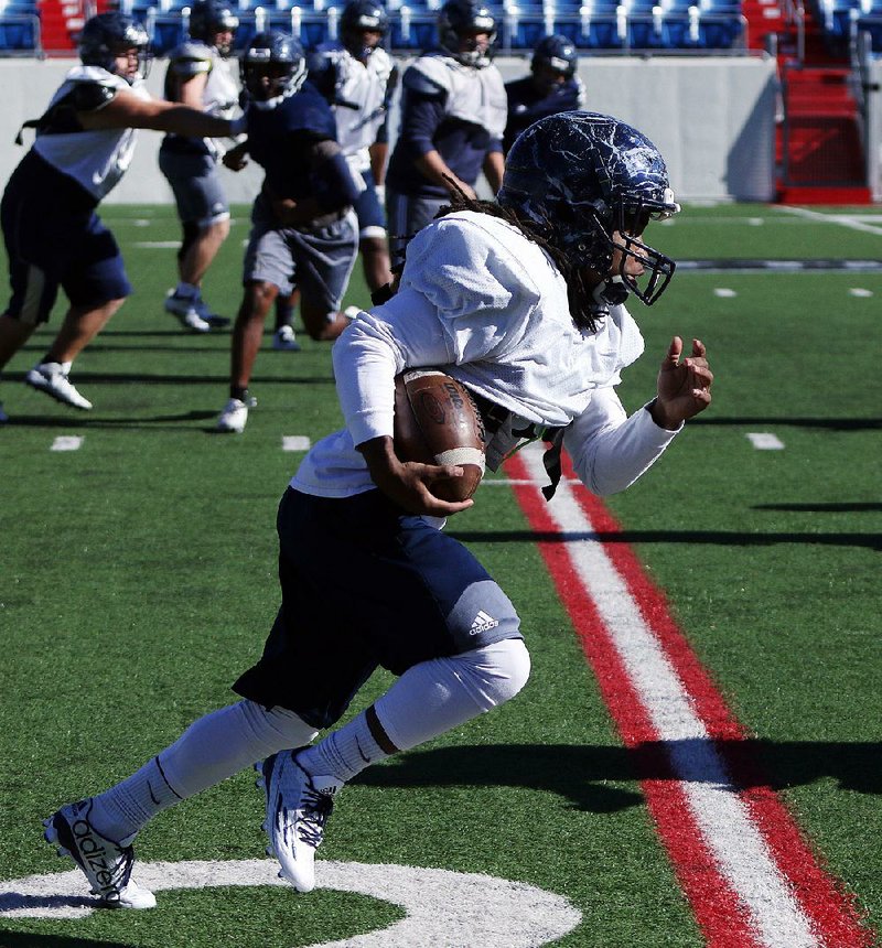 Pulaski Academy running back Jaren Watkins runs a play during Thursday’s practice at War Memorial Stadium in Little Rock.Watkins has rushed for 1,621 yards and 17 touchdowns on 179 carries this season and has caught 27 passes for 385 yards and 3 touchdowns.