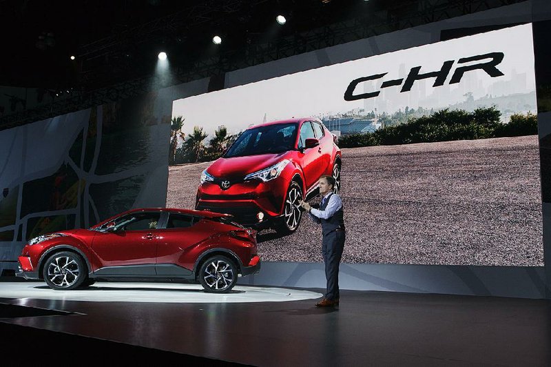 Bill Fay, group vice president and general manager at Toyota Motor Corp., speaks during the unveiling of the Toyota C-HR coupe at the Los Angeles Auto Show in November. Fay said Thursday that 2016 auto sales will come close to matching 2015’s record year.