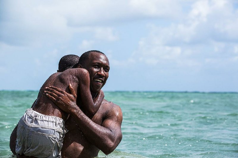 Alex Hibbert (left) and Mahershala Ali star in Moonlight, the story of the life of a young black man growing up in a rough neighborhood in Miami who struggles to find his place in the world.
