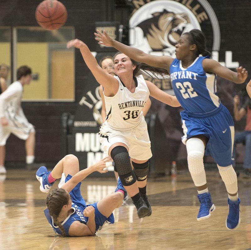 Bentonville High’s Anna Kash (30) contends for the ball with Bryant’s Kalia Walker on Thursday at Bentonville High School.