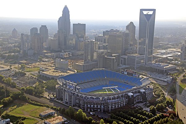 In this Aug. 16, 2012 file photo, the skyline of Charlotte, N.C., rises behind Bank of America Stadium in this aerial photo. The Belk Bowl will be played at the stadium on Thursday, Dec. 29, 2016. (AP Photo/Chuck Burton, File)