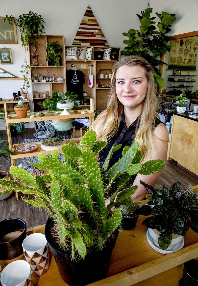 Overwatering is the most likely cause of succulent failure, warns Shannon Shrum, co-owner of Electric Ghost, a screen-printing business that includes a succulent and cacti plant lab in its retail space in downtown Little Rock. She’s shown here with an opuntia cactus (front left).