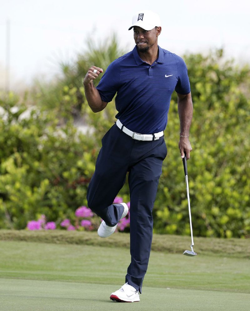 Tiger Woods reacts after making a par-saving putt on the 16th hole at the Hero World Challenge on Friday. Woods shot a bogey-free, 7-under-par 65 on Friday.