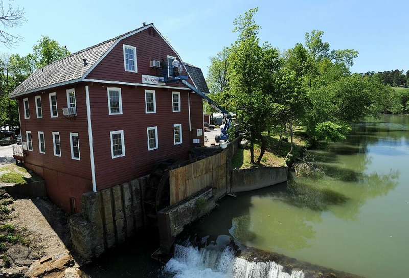 The exterior of the War Eagle Mill gets a new coat of paint in May. The sale of the mill will include its grain-production business.