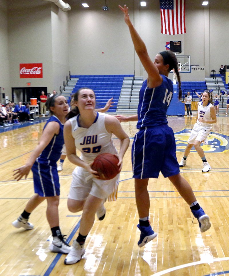 Photo courtesy of JBU Sports Information John Brown freshman Ally Teague looks for her shot as Oklahoma City&#8217;s Janae Haag defends in the Stars&#8217; 75-62 win over the Golden Eagles on Thursday at Bill George Arena.