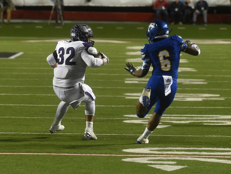 Fayetteville Highs Kester Olson (32) shakes North Little Rock’s Wynton Ruth as he returns a fumble for a touchdown during the second half Friday at War Memorial Stadium in Little Rock.