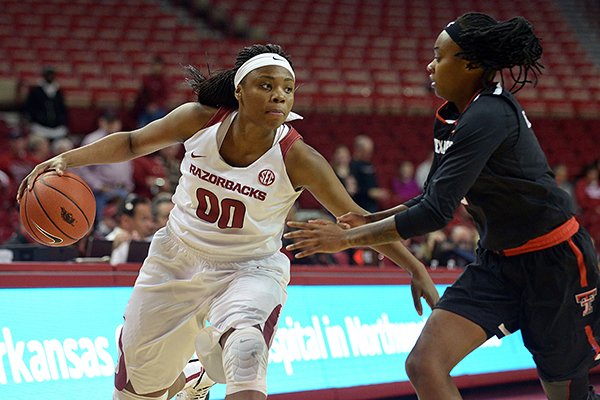 Jessica Jackson (00) of Arkansas drives down court as Ivonne Cook-Taylor (2) of Texas Tech guards on Saturday Dec. 3, 2016 during the game at Bud Walton Arena in Fayetteville.