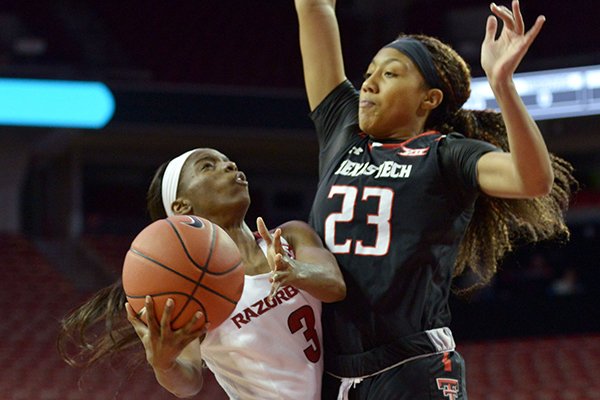 Malica Monk (3) of Arkansas shoots as Arella Guirantes (23) of Texas Tech defends on Saturday Dec. 3, 2016 during the game at Bud Walton Arena in Fayetteville.