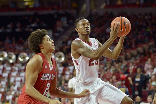 C.J. Jones of Arkansas shoots over defense from Jared Savage of Austin Peay on Saturday Dec. 3, 2016 during the game at Bud Walton Arena in Fayetteville.