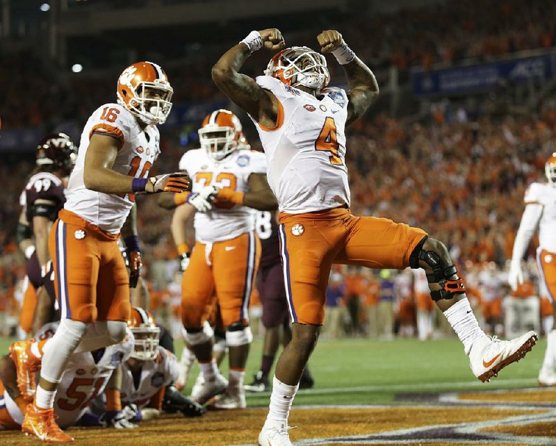 Clemson quarterback Deshaun Watson flexes his muscles after scoring a touchdown Saturday during the No. 3 Tigers’ 42-35 victory over No. 23 Virginia Tech in the ACC Championship Game at Camping World Stadium in Orlando.