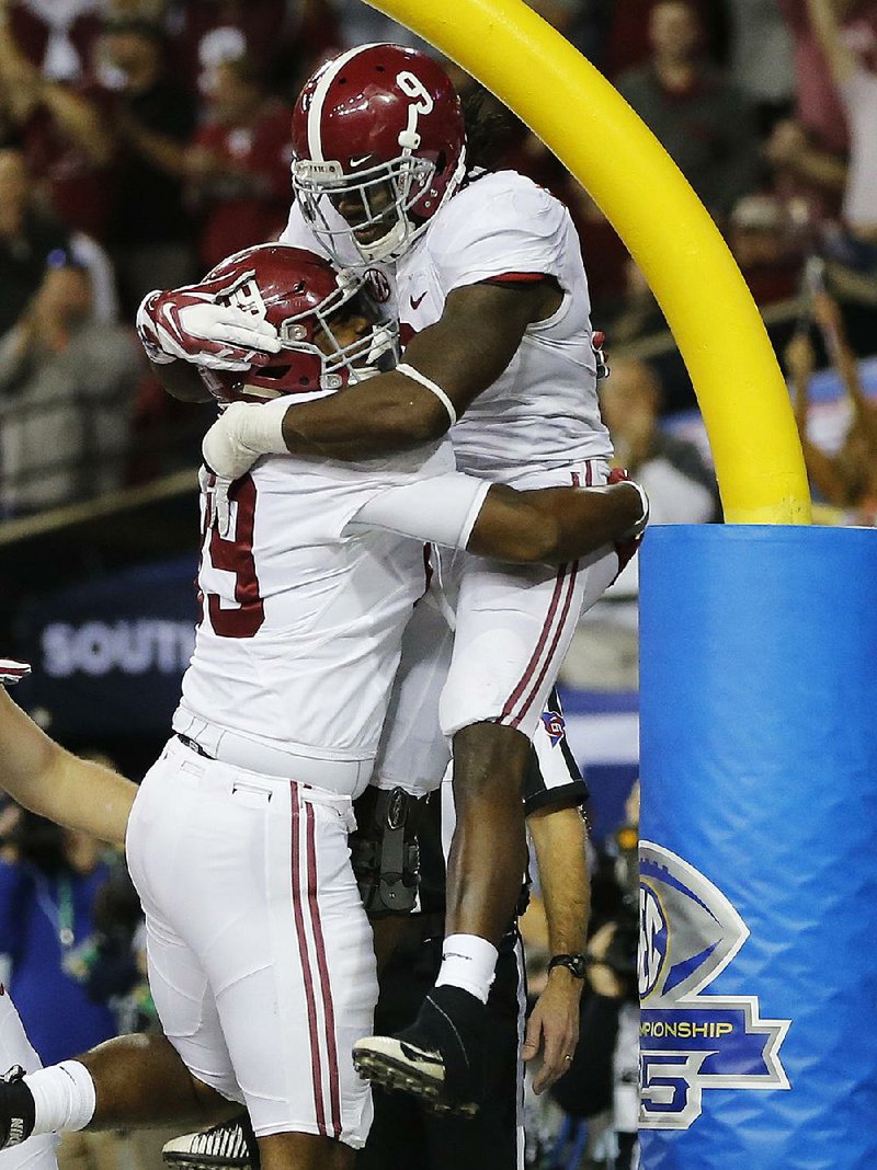 Alabama running back Bo Scarbrough (9) celebrates his touchdown against Florida with Alabama offensive lineman Dallas Warmack (59) during the second half of the Southeastern Conference championship NCAA college football game, Saturday, Dec. 3, 2016, in Atlanta.(AP Photo/John Bazemore)