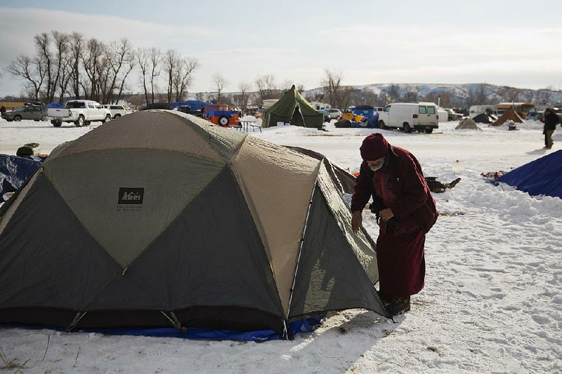 Marine Corps veteran Allan Newman enters his tent Saturday at a camp in Cannon Ball, N.D., where people have gathered to protest the Dakota Access oil pipeline.