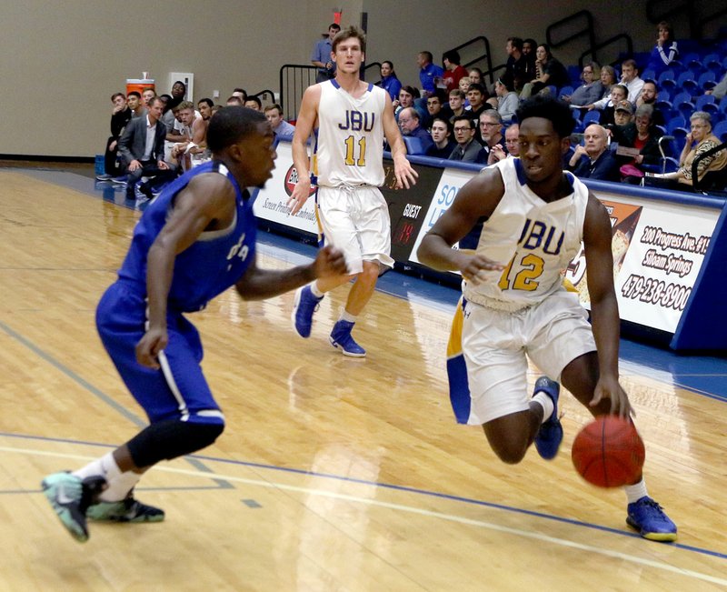 Photo courtesy of JBU Sports Information John Brown sophomore Marquis Waller drives to the basket in the first half of the Golden Eagles&#8217; 84-76 loss to Oklahoma City on Thursday at Bill George Arena.