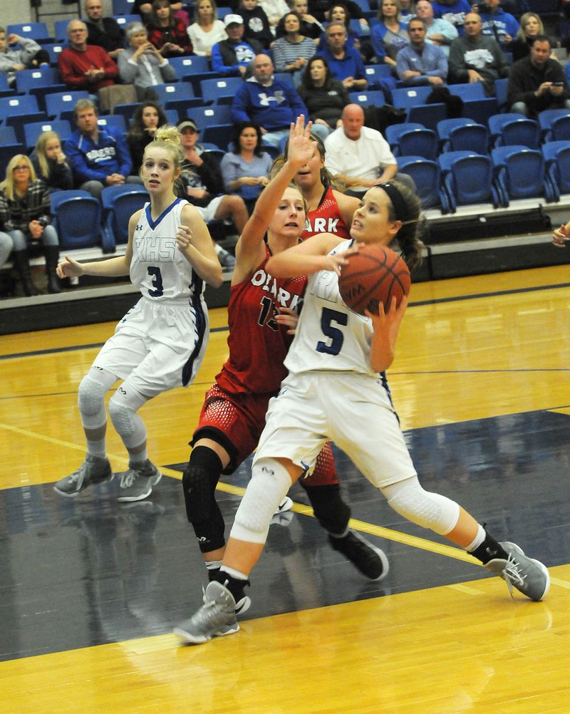 Emma Wisdom (5) of Rogers High goes up for a shot while Kelsey Richmond (3) of Ozark, Mo., defends Saturday.