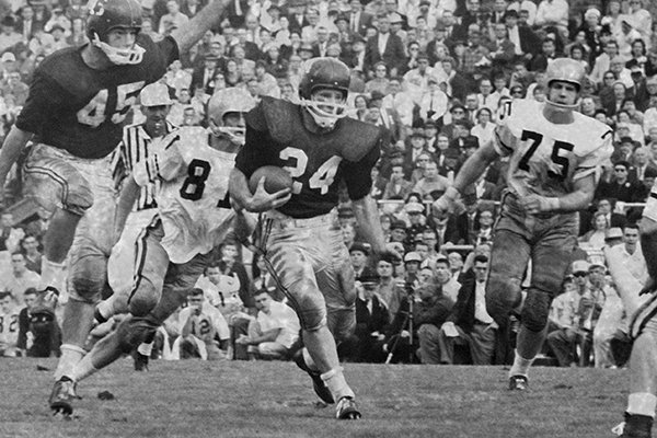 Jim Mooty, (24), Arkansas All America halfback, scoots 20 yards for the second and game-winning touchdown in the Gator Bowl game at Jacksonville, Florida,, Jan. 2, 1960. In the top panel Mooty appears headed for trouble as Georgia Tech defenders bear down. In the center panel Mooty sprints right through. In the bottom panel he heads for the goal line leaving two tech men behind, Arkansas won 14-0. (AP Photo/Jim Kerlin)