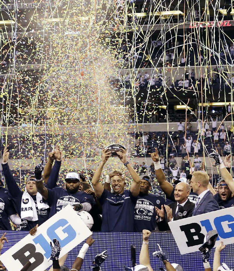 Penn State players celebrate with Coach James Franklin (center) after rallying from a 21-point defi cit to beat No. 8 Wisconsin 38-31 to win the Big 10 Championship on Saturday. The victory was the ninth in a row for the Nittany Lions, who have outscored their opponents 361-173 during that span and beat No. 3 Ohio State 24-21 on Oct. 22. Still, it wasn’t enough to sway the College Football Playoff committee, which selected Washington to join Alabama, Clemson and Ohio State in its final four.