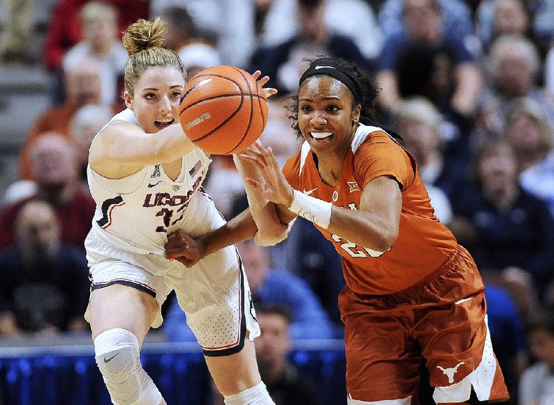 Connecticut’s Katie Lou Samuelson (left) and Texas’ Brianna Taylor (right) battle for the ball during No. 2 Connecticut’s 72-54 win over No. 14 Texas Sunday. The victory extended Connecticut’s winning streak to 82 games.
