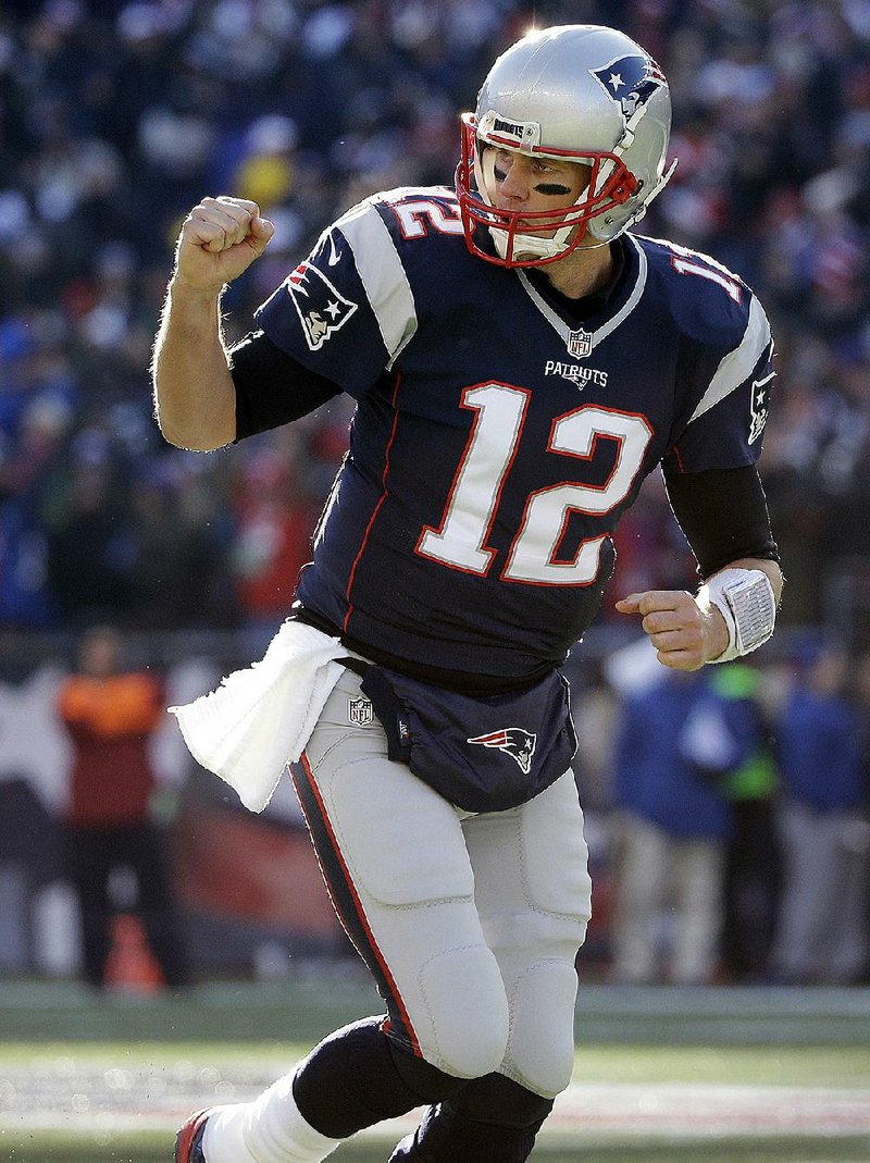 New England Patriots quarterback Tom Brady celebrates a touchdown run by LeGarrette Blount on Sunday. The Patriots won 26-10, giving Brady his 201st career victory.