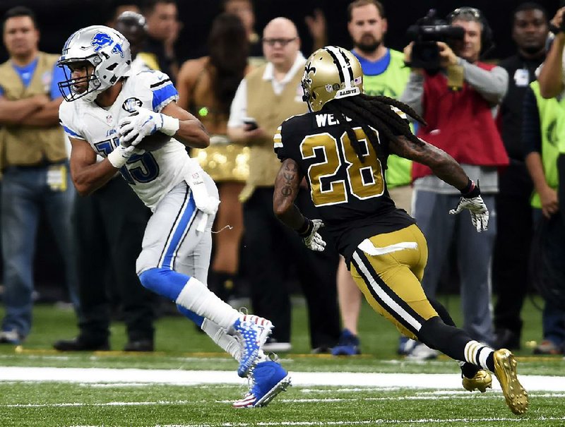 Detroit Lions wide receiver Golden Tate (15) pulls in a pass in front of New Orleans Saints cornerback B.W. Webb (28) during the fourth quarter Sunday in New Orleans. Tate turnd the catch into a 66-yard touchdown as the Lions won 28-13. Tate finished with 8 catches for 145 yards.