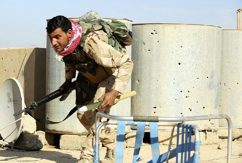 An Iraqi army soldier fights Islamic State militants from a rooftop on the front line in the Shaimaa neighborhood of Mosul, Iraq, on Sunday.