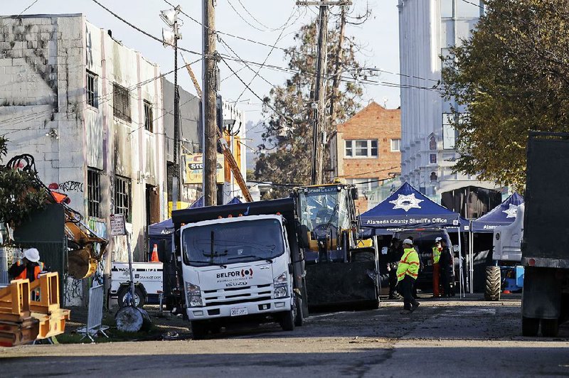 Cleanup continues Sunday at the scene of a warehouse fire in Oakland, Calif., where dozens of people died late Friday.
