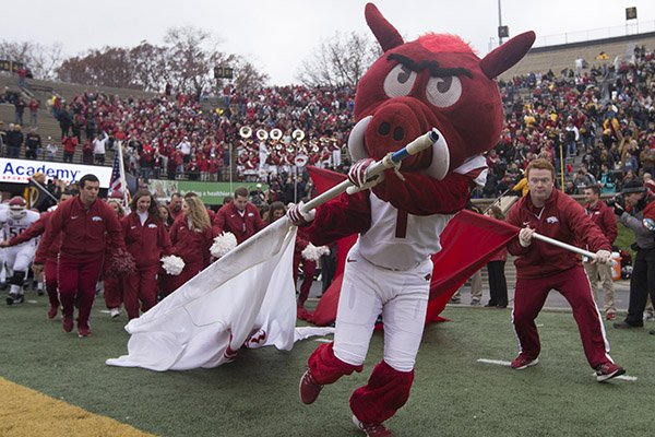 Arkansas' mascot and cheerleaders lead the team onto the field prior to a game against Missouri on Friday, Nov. 25, 2016, in Columbia, Mo.