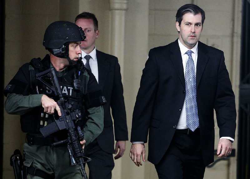 Former police officer Michael Slager (right) leaves the courthouse Monday under the protection of the Charleston County sheriff’s office after a mistrial was declared for his case in Charleston, S.C.