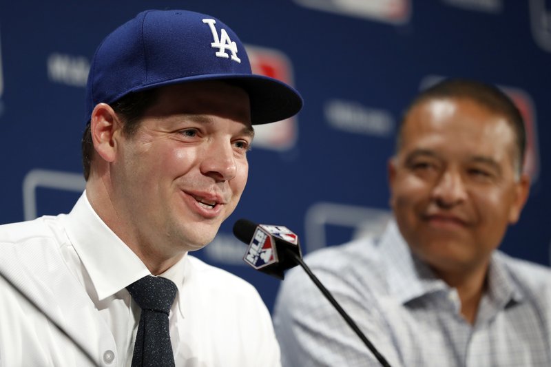 Los Angeles Dodgers pitcher Rich Hill, left, speaks as manager Dave Roberts looks on during a media availability at Major League Baseball's winter meetings, Monday, Dec. 5, 2016 in Oxon Hill, Md. Hill recently signed a 3-year deal to stay with the Dodgers. 