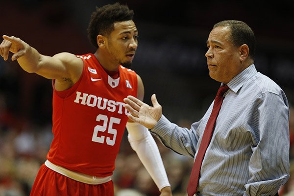 Houston head coach Kelvin Sampson talks with guard Galen Robinson Jr. (25) during the second half of an NCAA college basketball game Wednesday, Jan. 13, 2016, in Cincinnati. Cincinnati won 70-59. (AP Photo/Gary Landers)