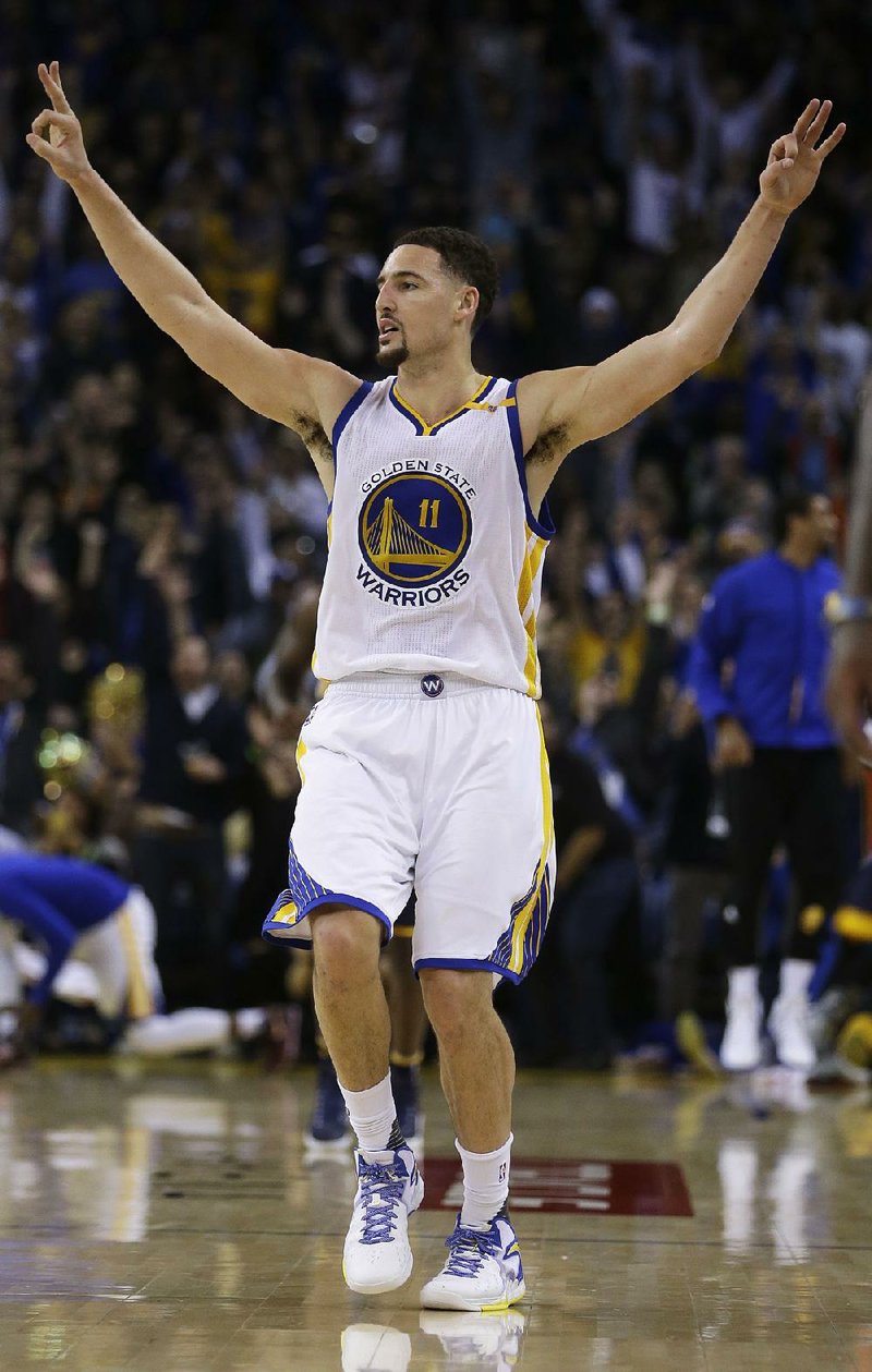 Golden State’s Klay Thompson celebrates a three-pointer in Monday’s 142-106 victory over Indiana in Oakland, Calif. Thompson scored 60 points in only 29 minutes and did not play in the fourth quarter. He was 8 of 14 on three-pointers and 21 of 33 overall from the floor. Three other 60-point games have been recorded this decade, but each of them required at least 39 minutes on the floor. 